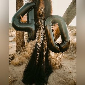 Beautiful long black & gold size 2-4 gown. Soft bottom flair. Lace back.